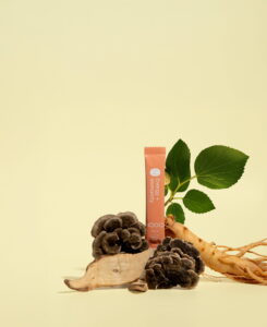 Nooci supplement product displayed with traditional herbs and mushrooms