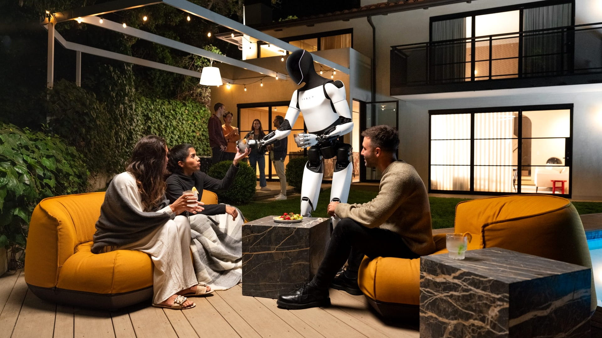 Tesla Optimus humanoid robot interacting with people in a home setting