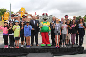 Transportation Minister Steven Del Duca, Elmer the Safety Elephant and friends give thumbs up to the new rules of the road