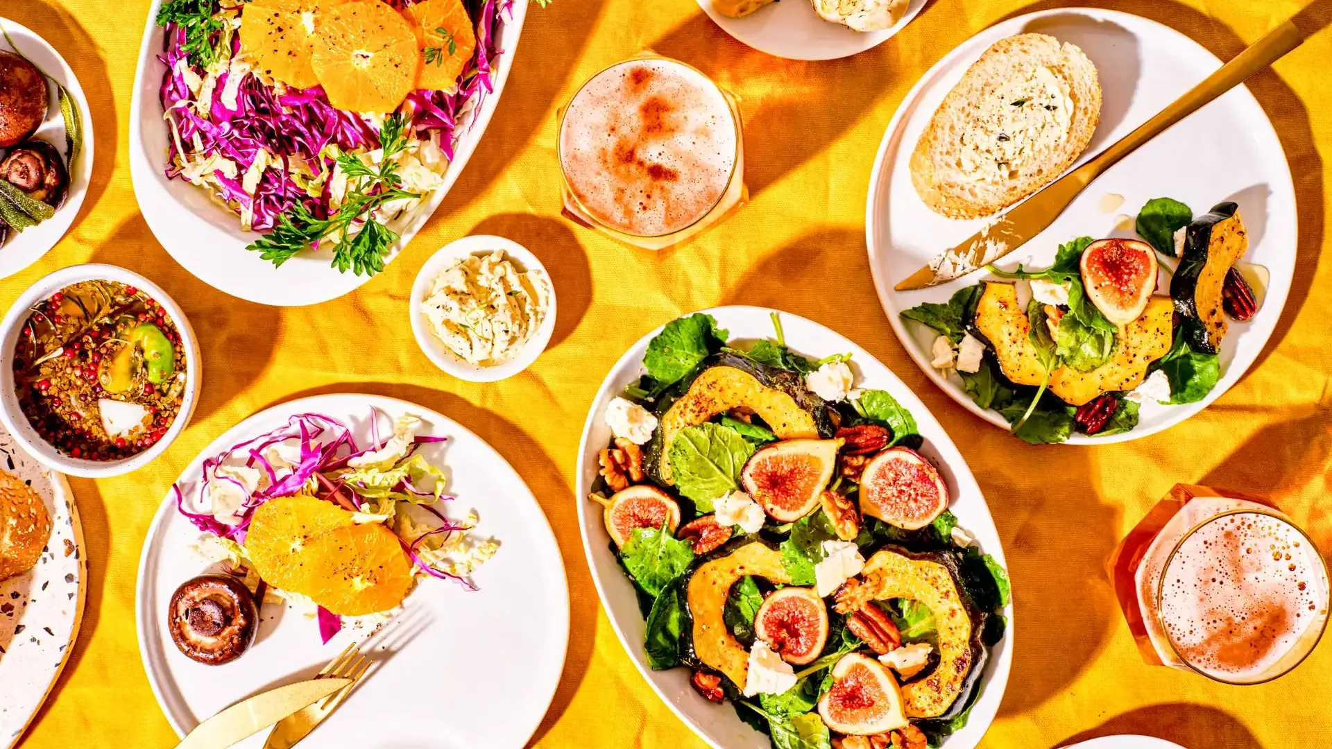 Table full of plates filled with different foods