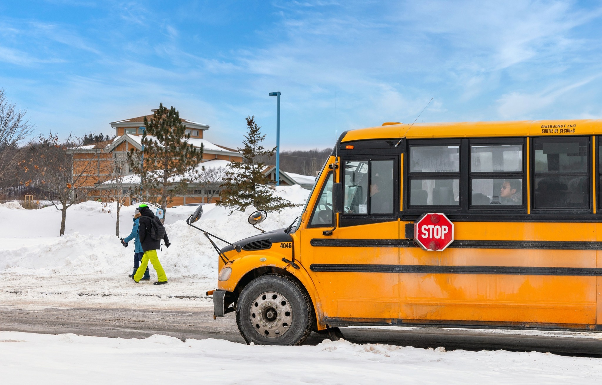 A yellow bus parked near a building.