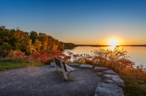 Sunset on the Ottawa River from a lookout with a bench