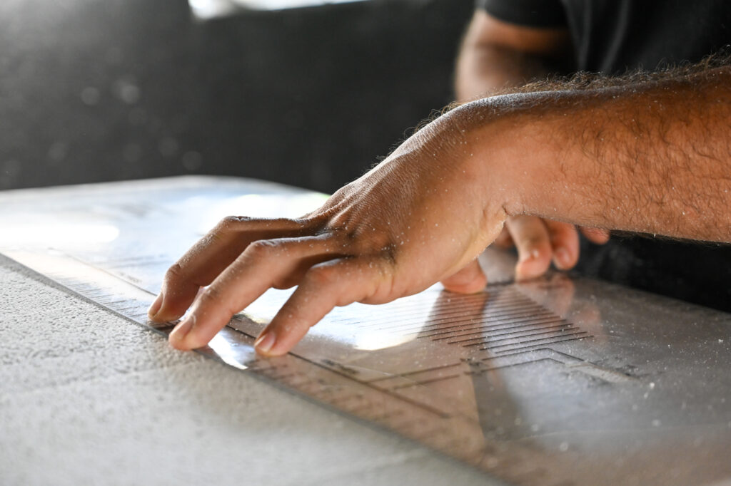 shaping the surfboard by hand