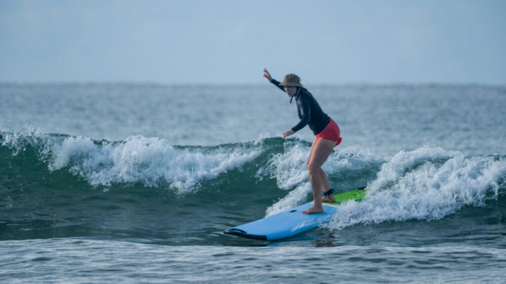 Surfing blue/green waves in Uvita, Osa, Costa Rica