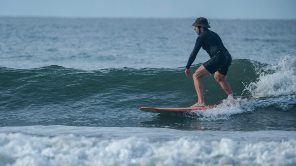 Surfing blue/green waves in Uvita, Osa, Costa Rica