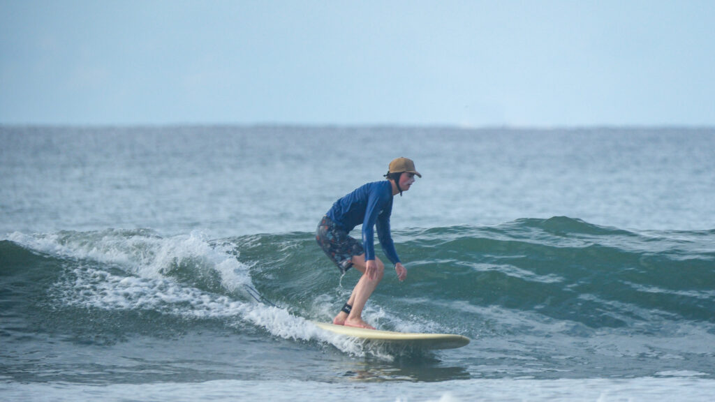 Surfing blue/green waves in Uvita, Osa, Costa Rica