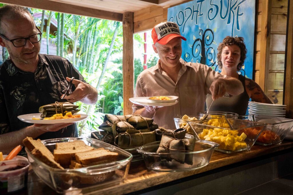 Guests and staff sharing a meal together at Bodhi Surf and Yoga, highlighting the safety of a community-integrated lodge in Costa Rica.