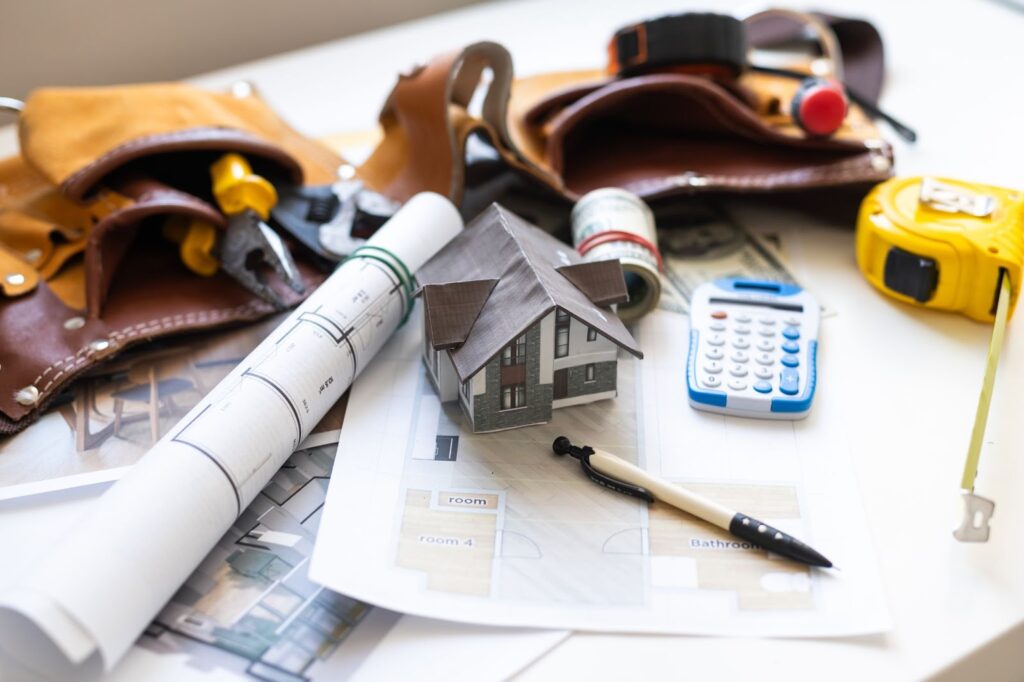 construction tools and home blueprint on a table. 