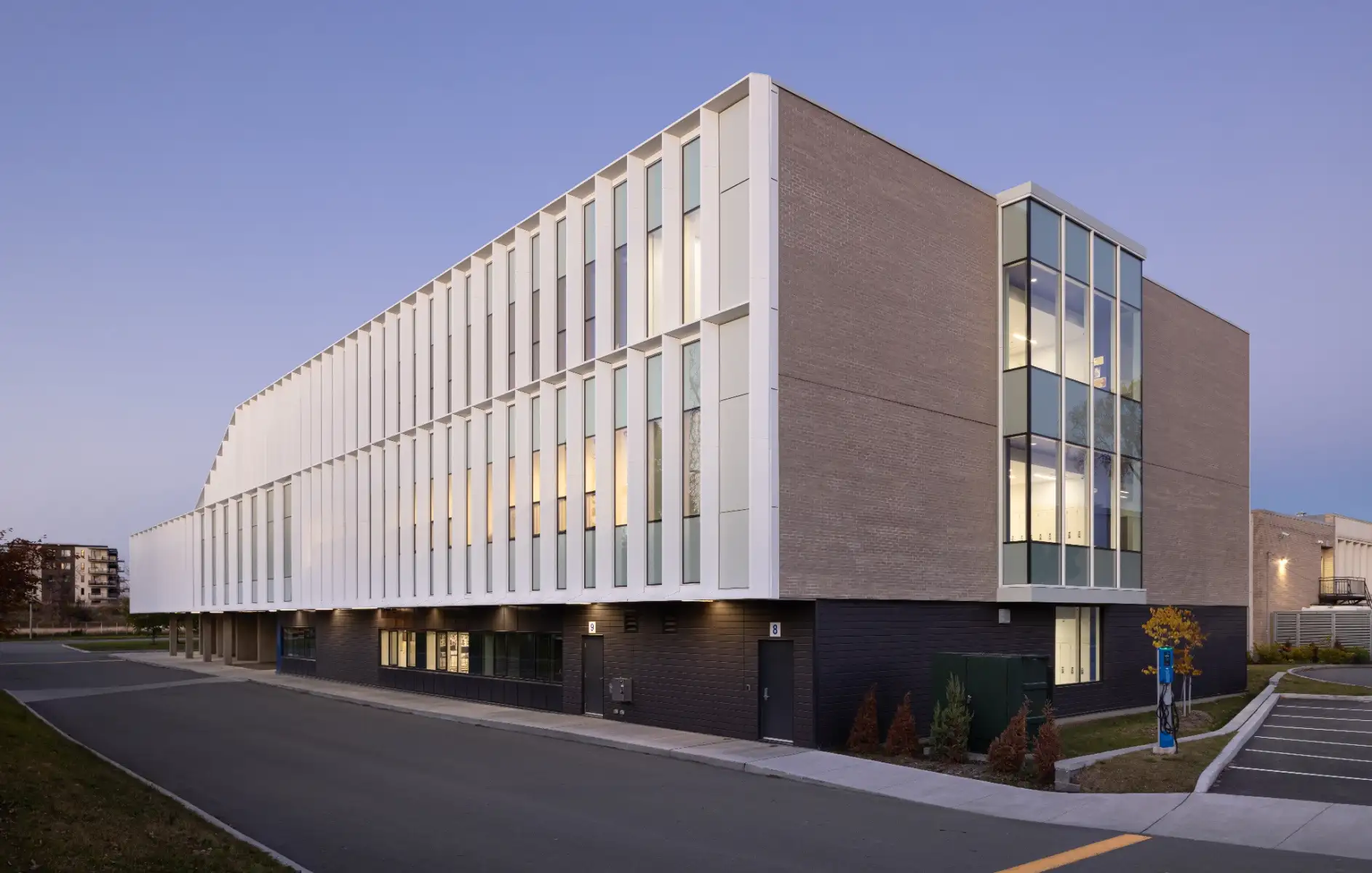 Vue extérieure de l’École Cardinal-Roy mettant en valeur son architecture contemporaine, ses volumes dynamiques et son enveloppe performante.