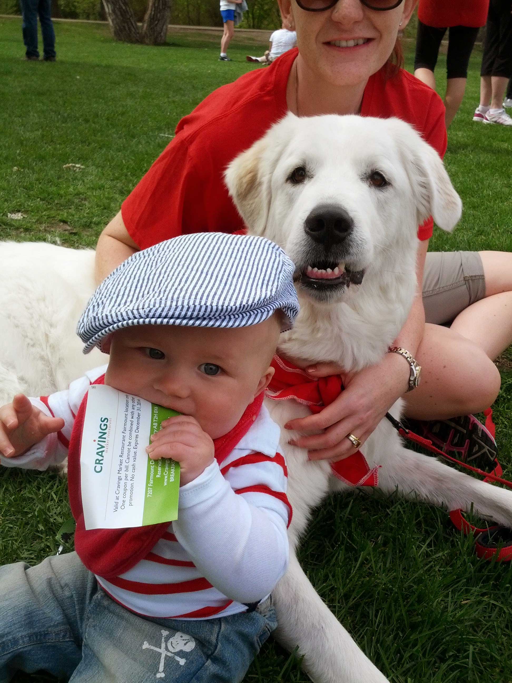 Rachel sitting with her dog and a baby.