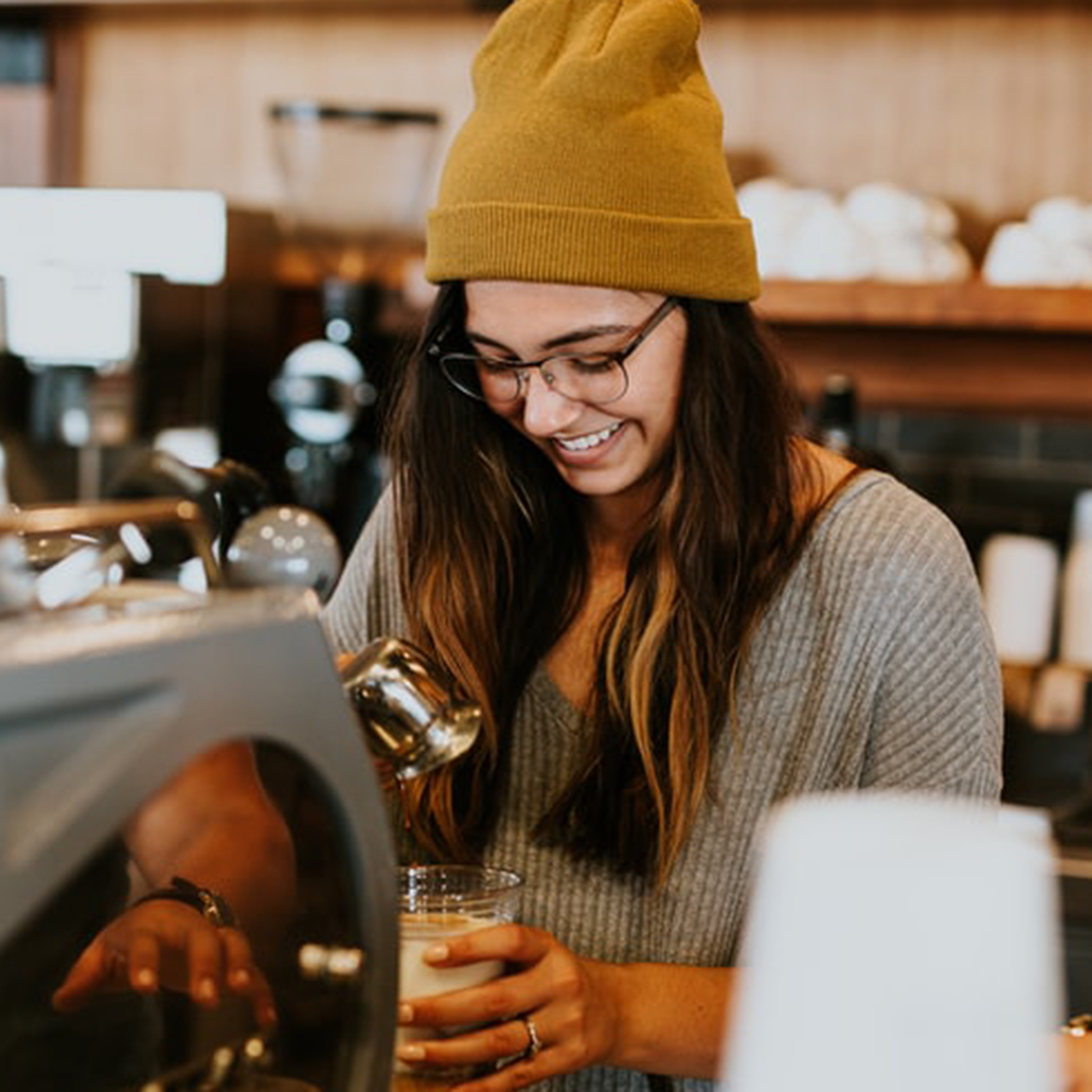 A friendly barista at Cafe Cat making a latte